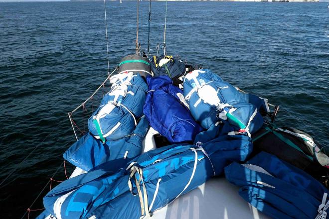 Bags of sails stored on the bow of a sailboat